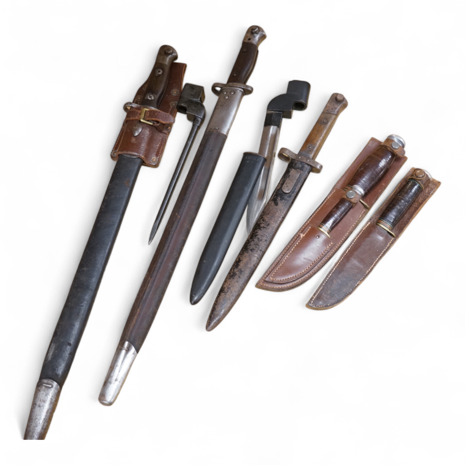 A 1907 bayonet by Wilkinson in its steel mounted leather scabbard, another similar with leather frog, two small British bayonets, a Continental bayonet, and two assorted hunting knives (7)